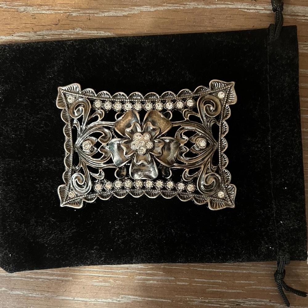 Beautiful solid perforated detailed flower, rhinestone belt buckle.